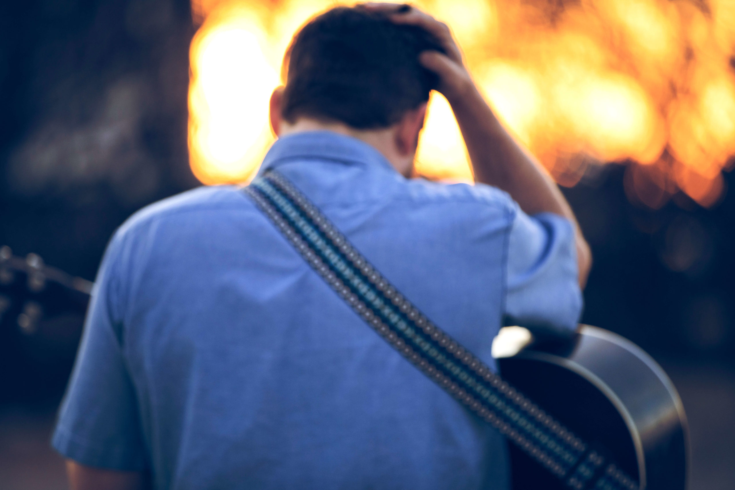 Ben Brock with his guitar at sunset